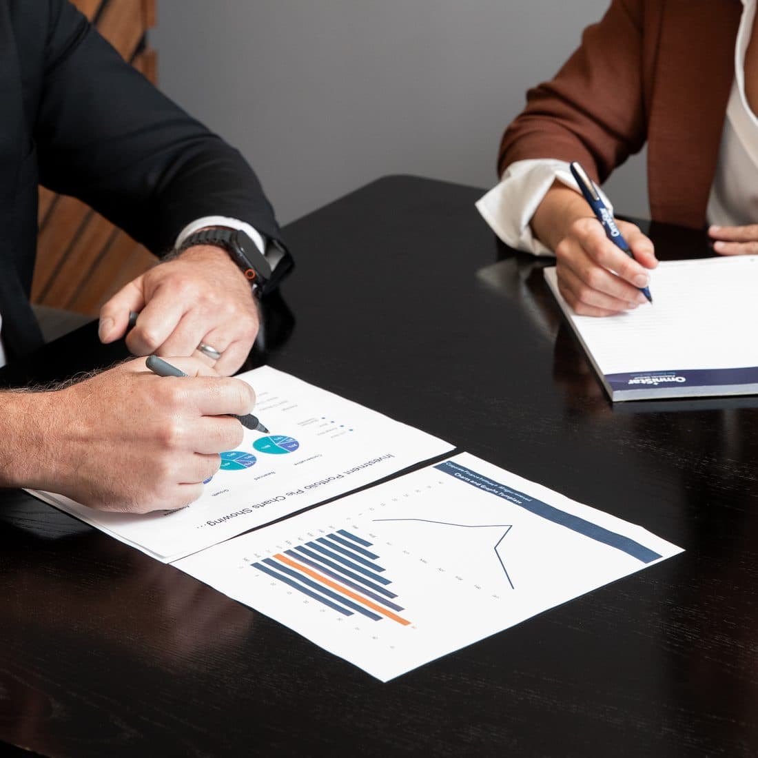 A pen resting on a printed chart during a plan review